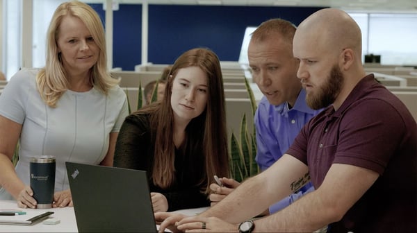ascensus-colleagues-meeting-table-laptop